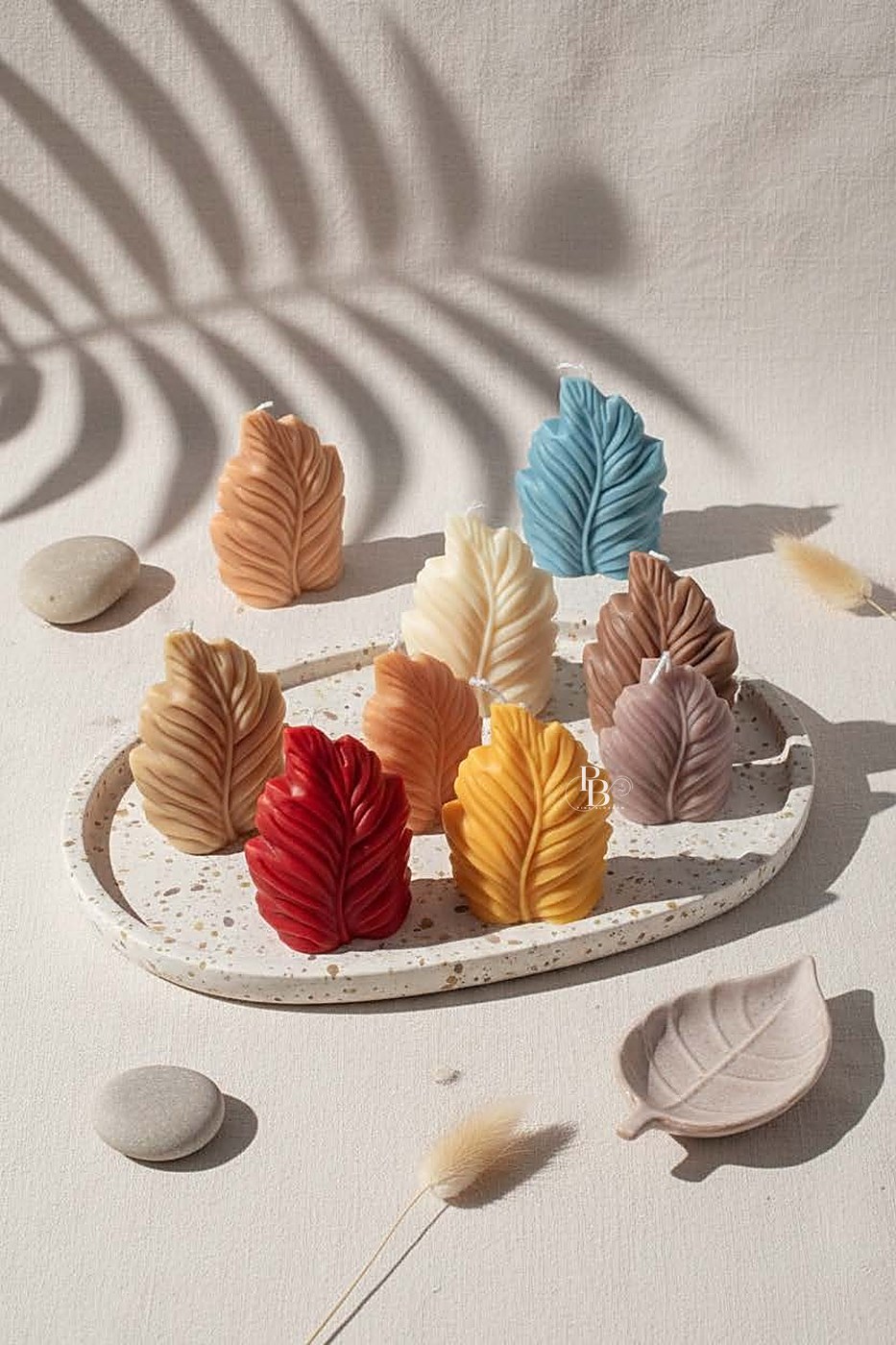 Sculpted leaf candles standing upright on a speckled tray, handmade soy wax, Pink Blossom bulk order