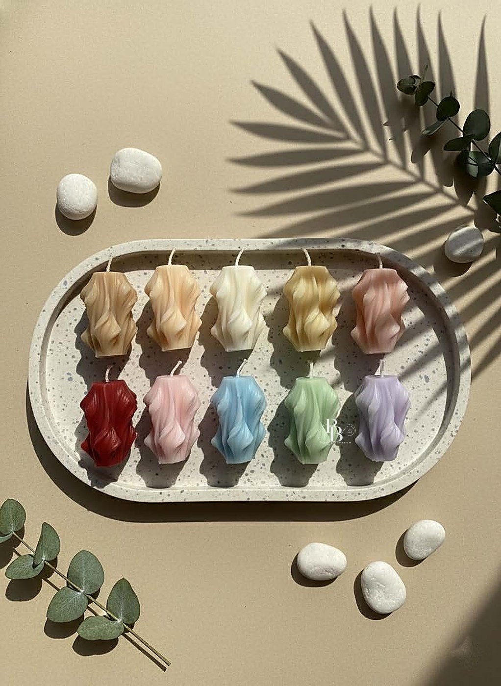 Wavy sculpted pillar candles in rows on an oval tray, handmade soy wax, Pink Blossom bulk order