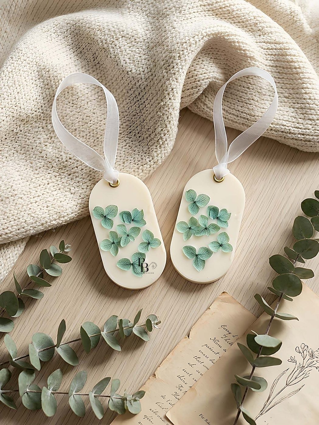 Oval wax sachets with green eucalyptus leaf designs on ribbon loops, handmade soy wax, Pink Blossom bulk order